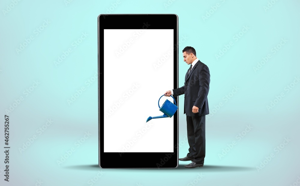 Full length of young guy leaning on giant mobile phone with an empty screen, Full length of young guy leaning on giant mobile phone with an empty screen,