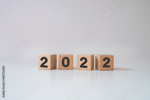 Abstract 2022 design concept - geometric wood blocks cubes on white background. New Beginning. copy space