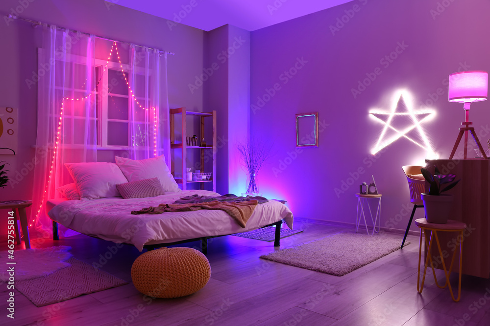 Interior of stylish bedroom with neon lighting - obrazy, fototapety, plakaty 