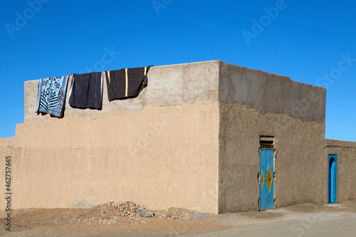 Morocco, Merzouga, Erg Chebbi, rammed earth building in oasis town Taouz photo