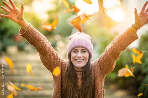 Carefree woman enjoying sunny autumn day