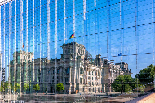 Germany, Berlin, Reichstag building mirrored in glass facade of Marie-Elisabeth-Lueders-Building photo