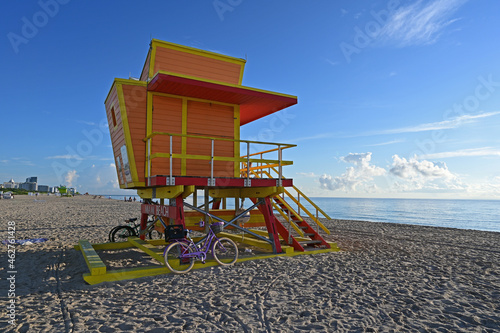 Colorful lifeguard station on Miami Beach, Florida under late summer cloudscape in early morning light.