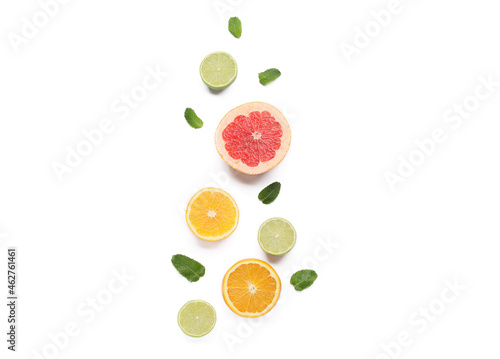 Composition with citrus fruits and mint leaves on white background