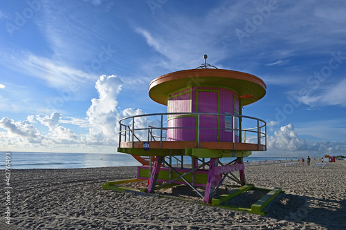 Colorful lifeguard station on Miami Beach, Florida under late summer cloudscape in early morning light. © Francisco