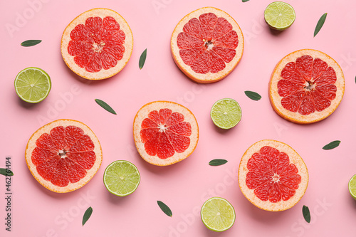 Composition with slices of ripe grapefruit and lime on color background