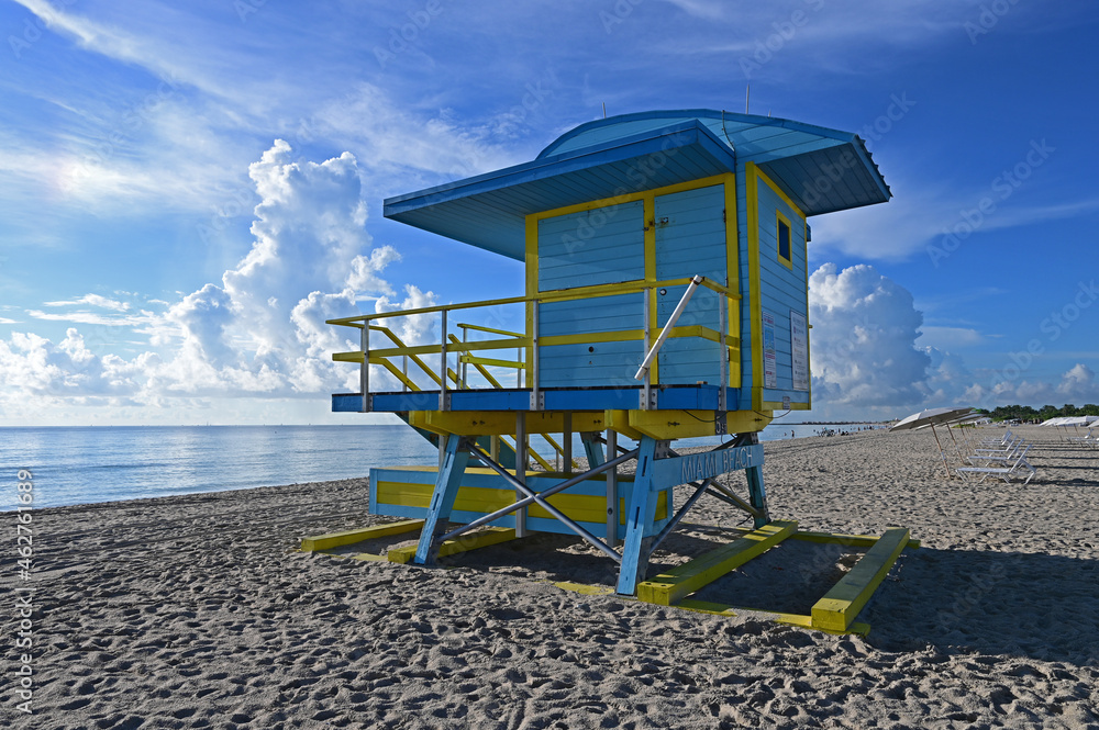 Colorful lifeguard station on Miami Beach, Florida under late summer cloudscape in early morning light.
