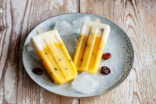 Homemade popsicles with mango and passion fruit photo