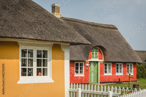 Denmark, Sonderho, Two colorful rustic houses with thatched roofs