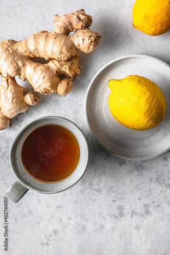 Studio shot of cup of tea, lemons and ginger root photo