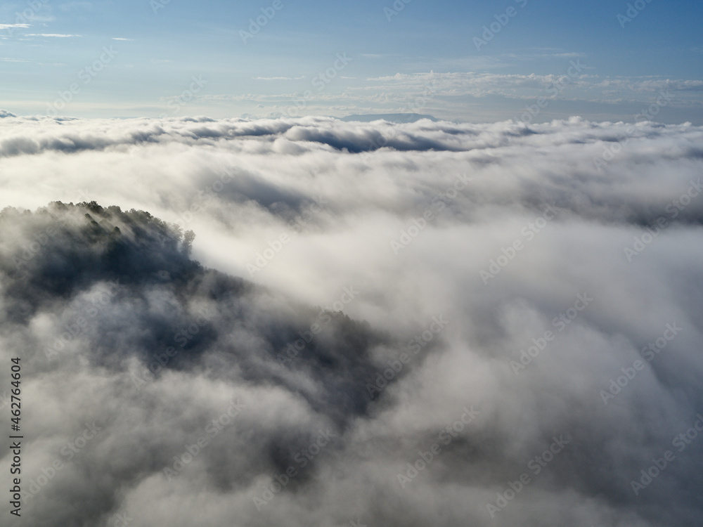 Aerial view of low clouds shrouding forested hills Aerial view of low clouds shrouding forested hills