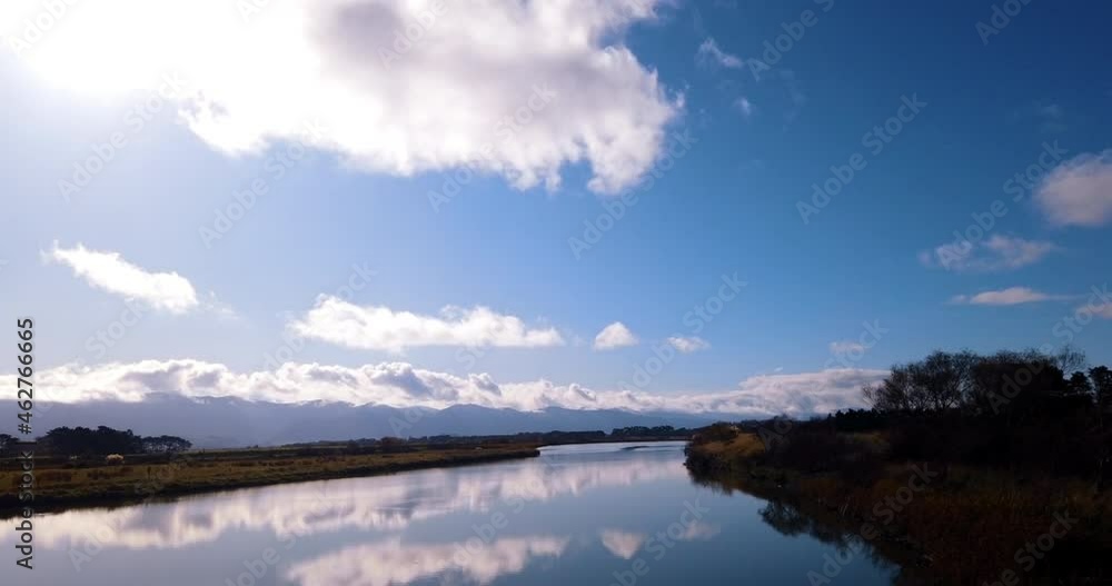 Time Lapse - Mirrored surface of Tauanui River, farmland and ranges - New Zealand Time Lapse - Mirrored surface of Tauanui River, farmland and ranges - New Zealand