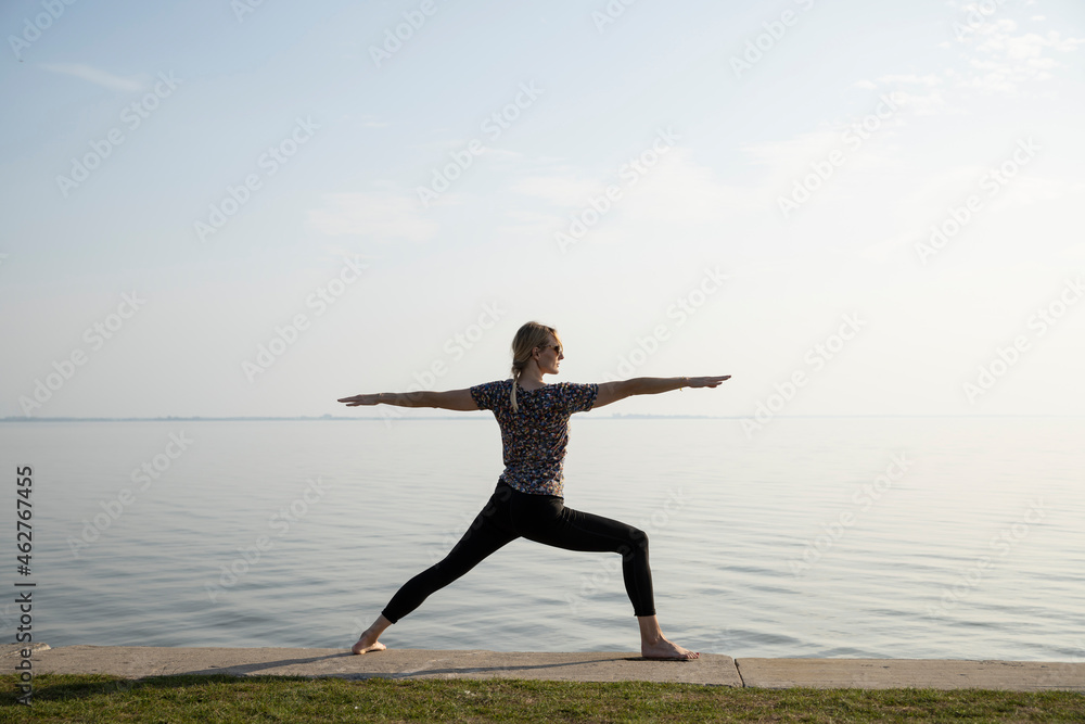Active woman practicing warrior position at promenade Active woman practicing warrior position at promenade