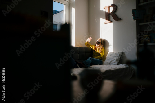 Girl at home shielding her eyes from sunshine