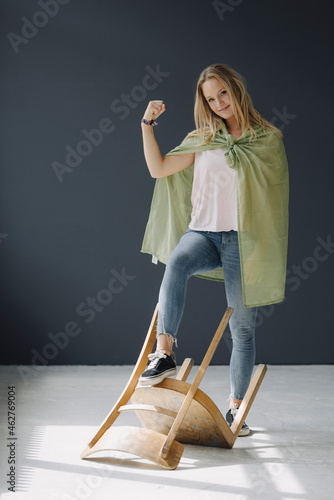 Portrait of blond young womanposing as a superheroine photo
