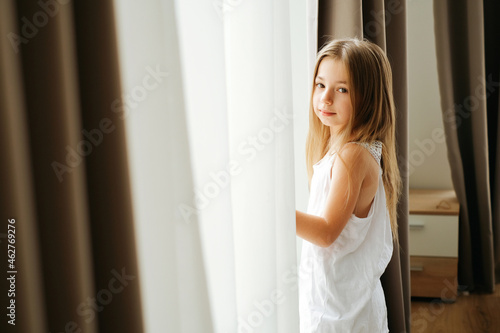 Little girl with long hair by the window Free Download Little girl with long hair by the window - GFXLoad