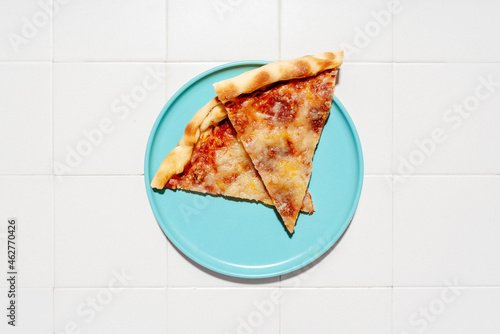 Two slices of pizza Margherita on blue plate  photo