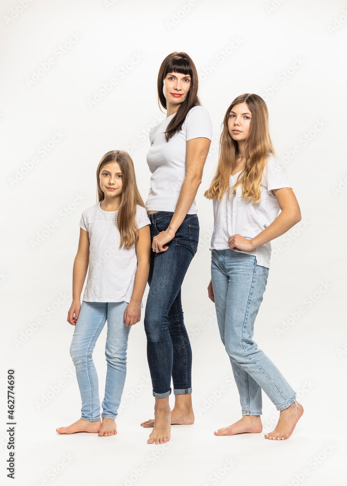 Mother standing with daughters against white background Mother standing with daughters against white background