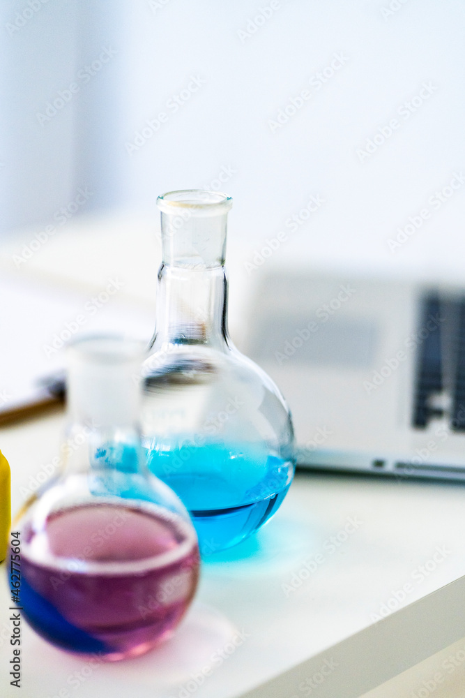 Beakers with chemical solution on table in chemistry lab Beakers with chemical solution on table in chemistry lab