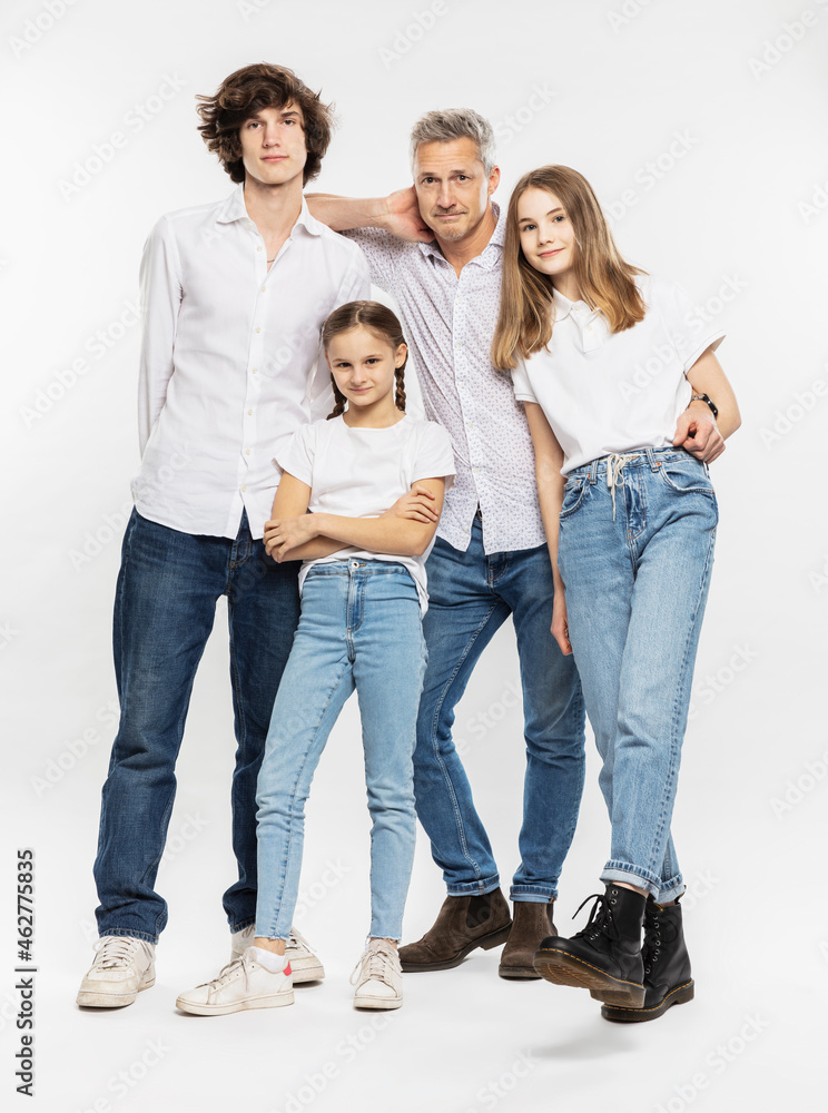 Father and children standing together against white background Father and children standing together against white background