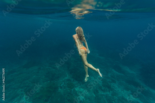 Young woman diving, Nusa Penida island, Bali, Indonesia photo