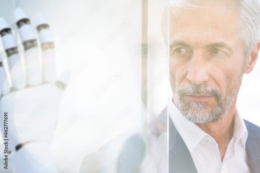 Businessman watching robot hand, close up