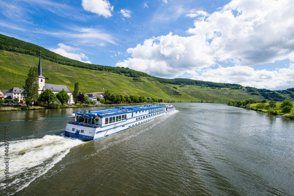 Cruise ship on Mosel River against cloudy sky, Bernkastel-kues, Germany