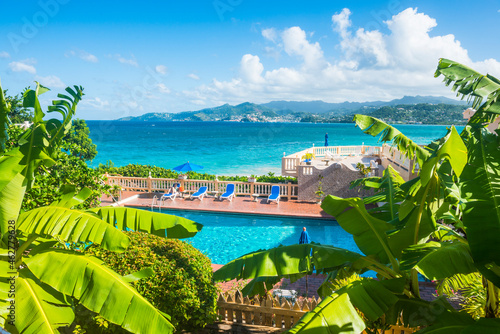 High angle view of swimming pool by sea against blue sky at Grenada, Caribbean photo