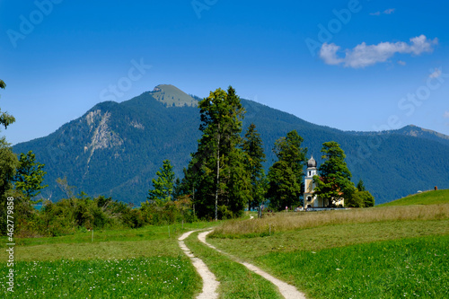 Germany, Upper Bavaria, Bavaria, Zwergern peninsula, Walchensee, Field and St. Margareth chapel with mountain in background photo