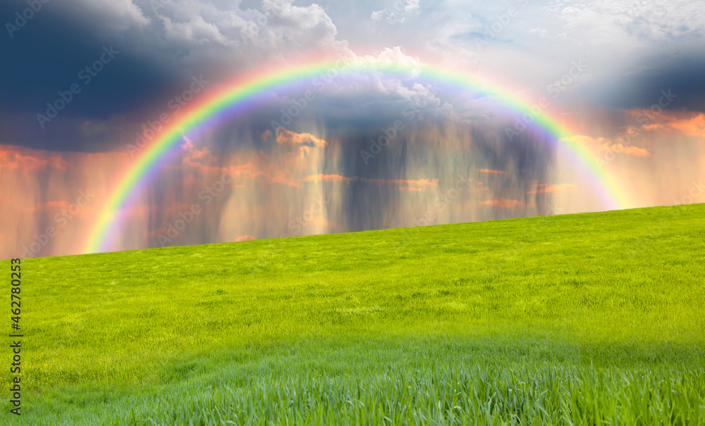 Rain over rural landscape with amazing rainbow at sunset Rain over rural landscape with amazing rainbow at sunset