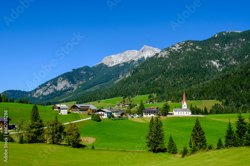 Austria, Tyrol, Steinberg am Rofan, Countryside village with Guffert in background photo