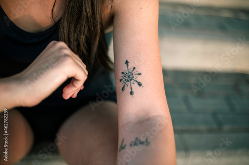 Tattoo on arm of young woman photo