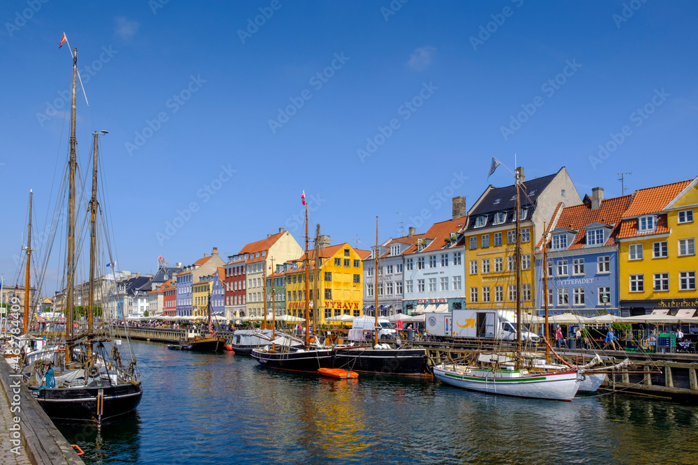 Denmark, Copenhagen, Boats moored along Nyhavn canal with colorful townhouses in background Denmark, Copenhagen, Boats moored along Nyhavn canal with colorful townhouses in background