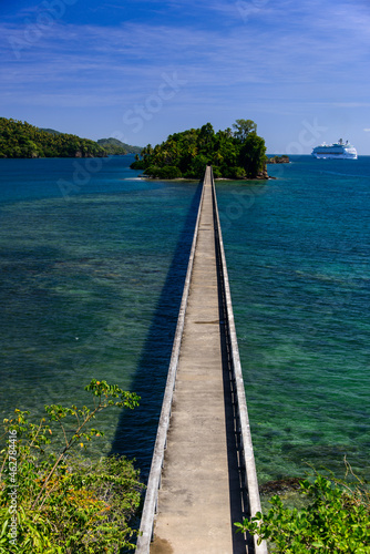 High angle view of empty footbridge leading towards island against blue sky, Samana peninsula, Dominican Republic photo