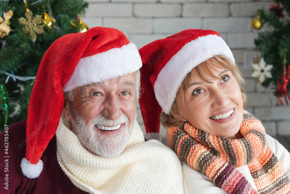 closeup portrait of two cheerful lovely sweet tender cute romantic married senior couple husband and wife in Santa hat celebrate Christmas together on Christmas and New Year celebration festival. closeup portrait of two cheerful lovely sweet tender cute romantic married senior couple husband and wife in Santa hat celebrate Christmas together on Christmas and New Year celebration festival.