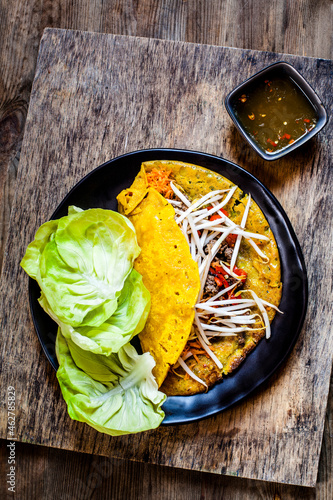 Banh xeo with lettuce and Nuoc Cham dipping sauce photo