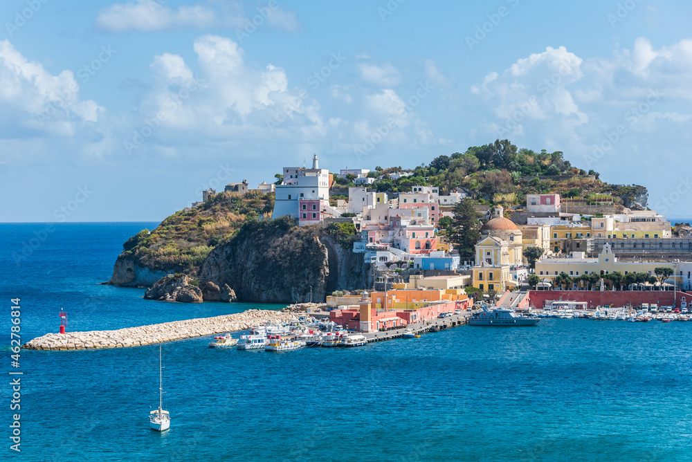 The port of the Ponza island in summer. Coloured houses, boats, ferry in the harbour of island of Ponza. Sunny day, blue water and fresh colours. Ponza, Lazio,  Italy