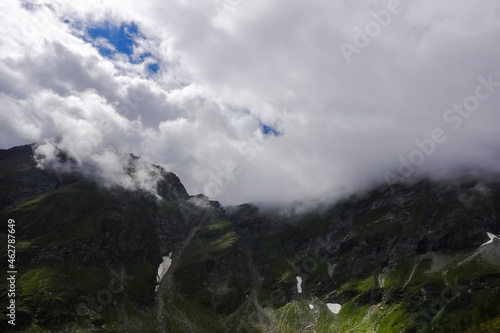 fog and clouds on the top of the mountains in the summer