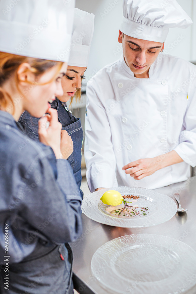 Junior chef showing his prepaired dessert on plate Junior chef showing his prepaired dessert on plate