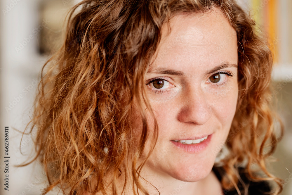 Close-up portrait of mid adult woman with wavy hair at home Close-up portrait of mid adult woman with wavy hair at home