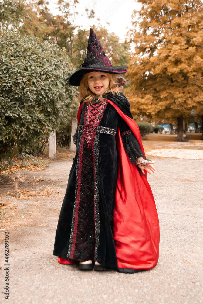 girl witch in a cloak that scatters in different directions on the holiday halloween sweets or life girl witch in a cloak that scatters in different directions on the holiday halloween sweets or life