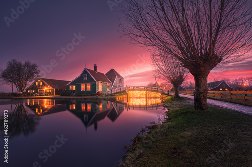 Netherlands, North Holland, Zaanse Schans, Riverside town houses at purple moody dawn photo