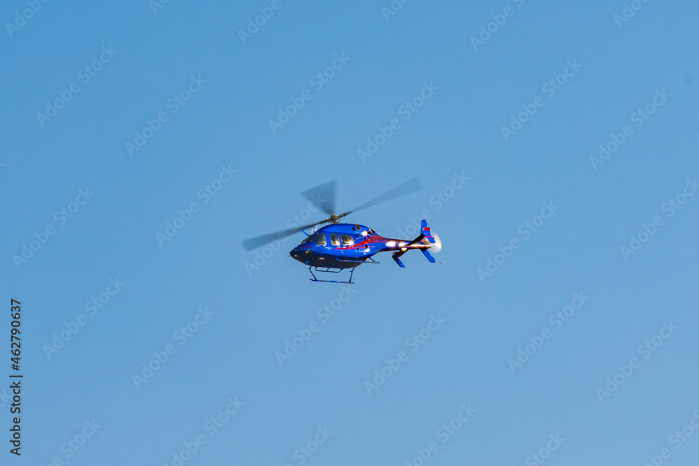Helicopter flying in the sky during a sunny day Helicopter flying in the sky during a sunny day
