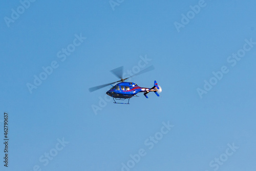Helicopter flying in the sky during a sunny day