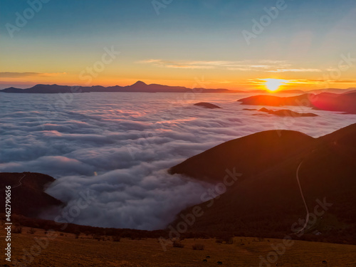 Italy, Marche, Apennines, Mount San Vicino at sunrise seen from mount Cucco photo