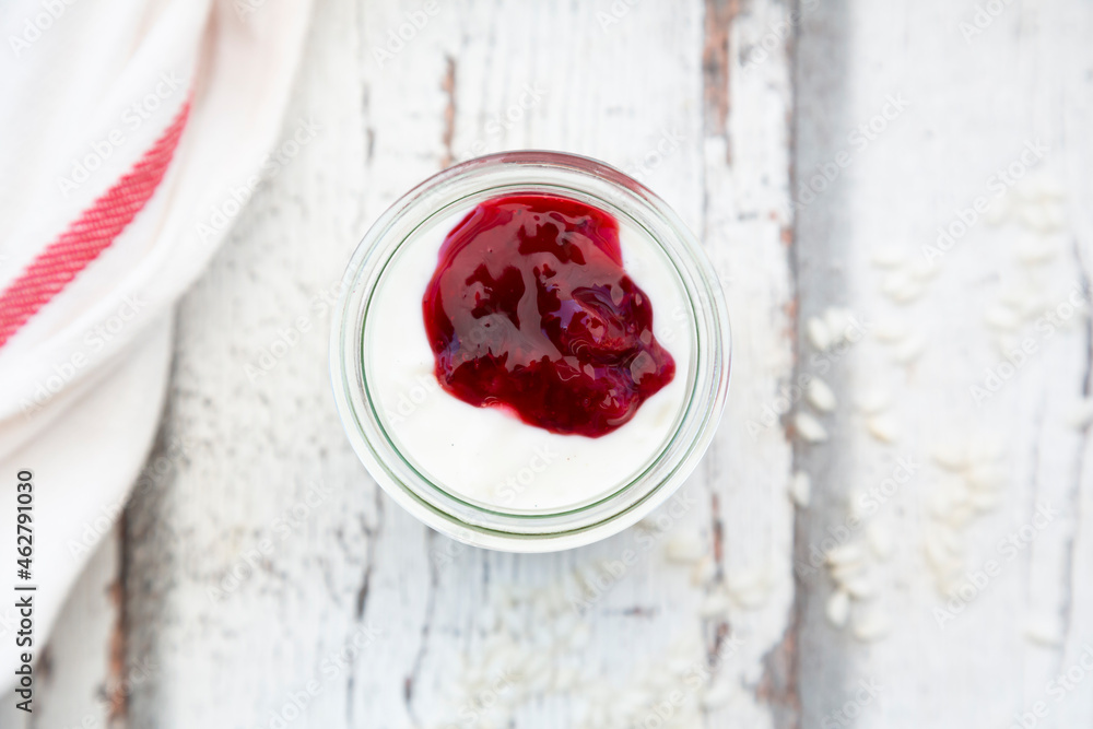 Glass of rice pudding with berry compote, top view Glass of rice pudding with berry compote, top view