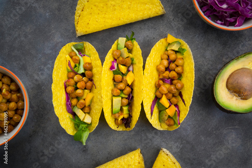Vegetarian tacos with curcuma, roasted chickpeas, paprika, avocado, salad and red cabbage photo