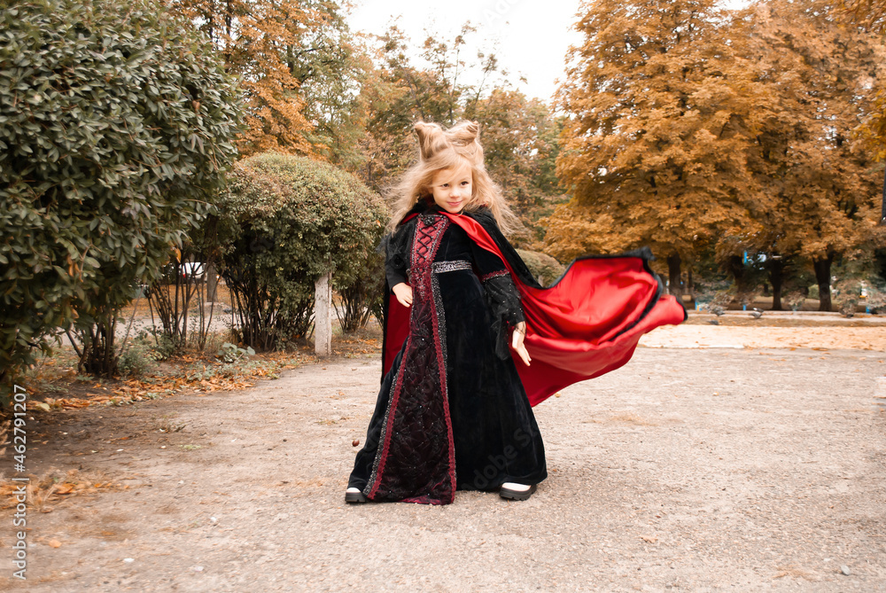cute little girl in a carnival costume for Halloween with horns on her head cute little girl in a carnival costume for Halloween with horns on her head