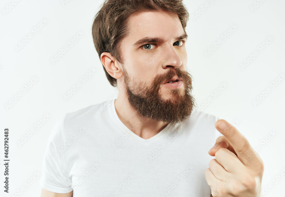 bearded man in a white t-shirt irritated facial expression Studio bearded man in a white t-shirt irritated facial expression Studio