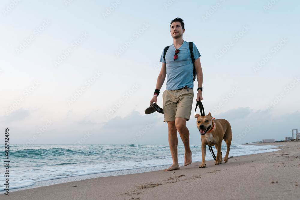 Man walking with his dog at beach Man walking with his dog at beach